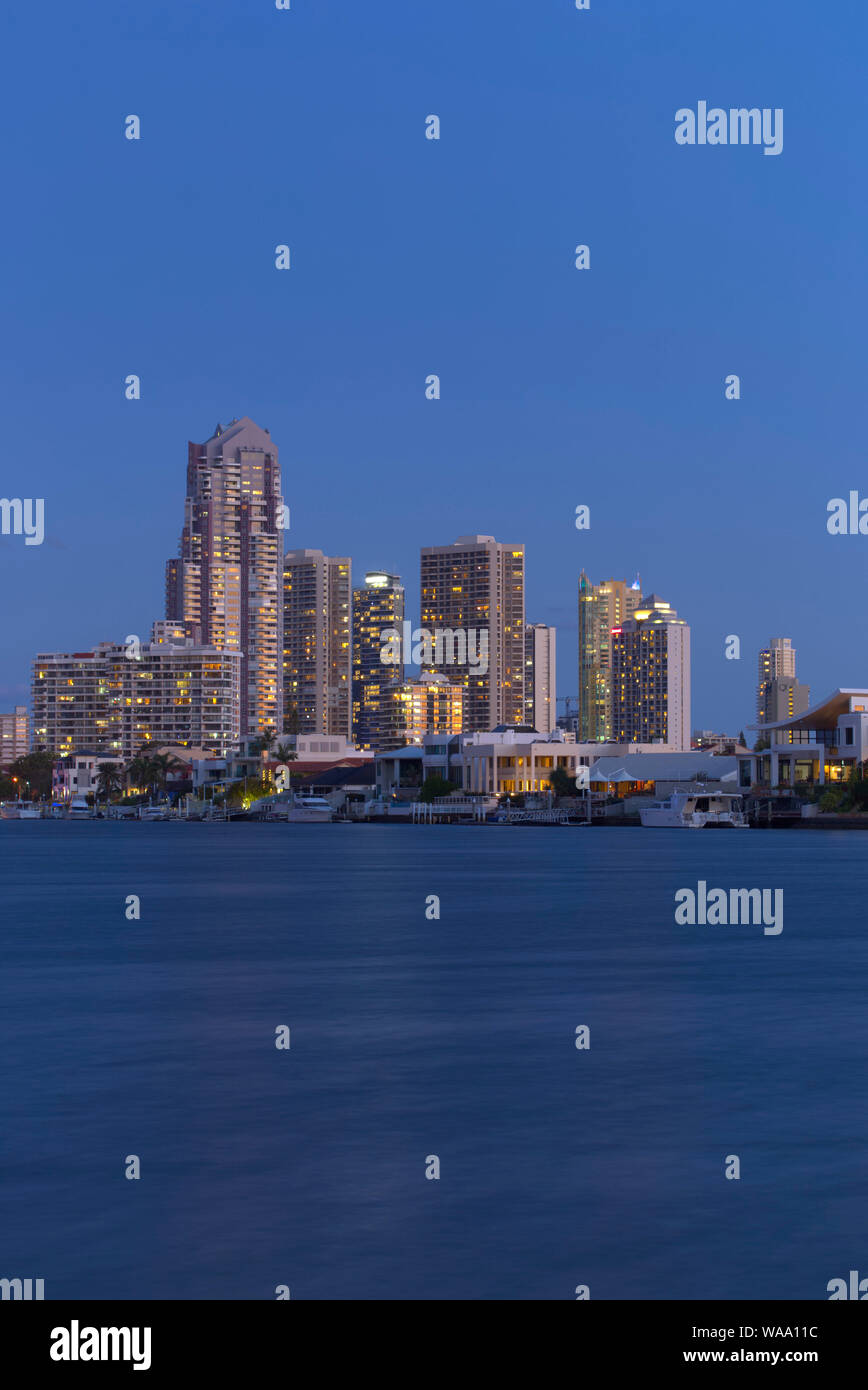 Sunset over luxury apartments and waterfront houses Gold Coast ...