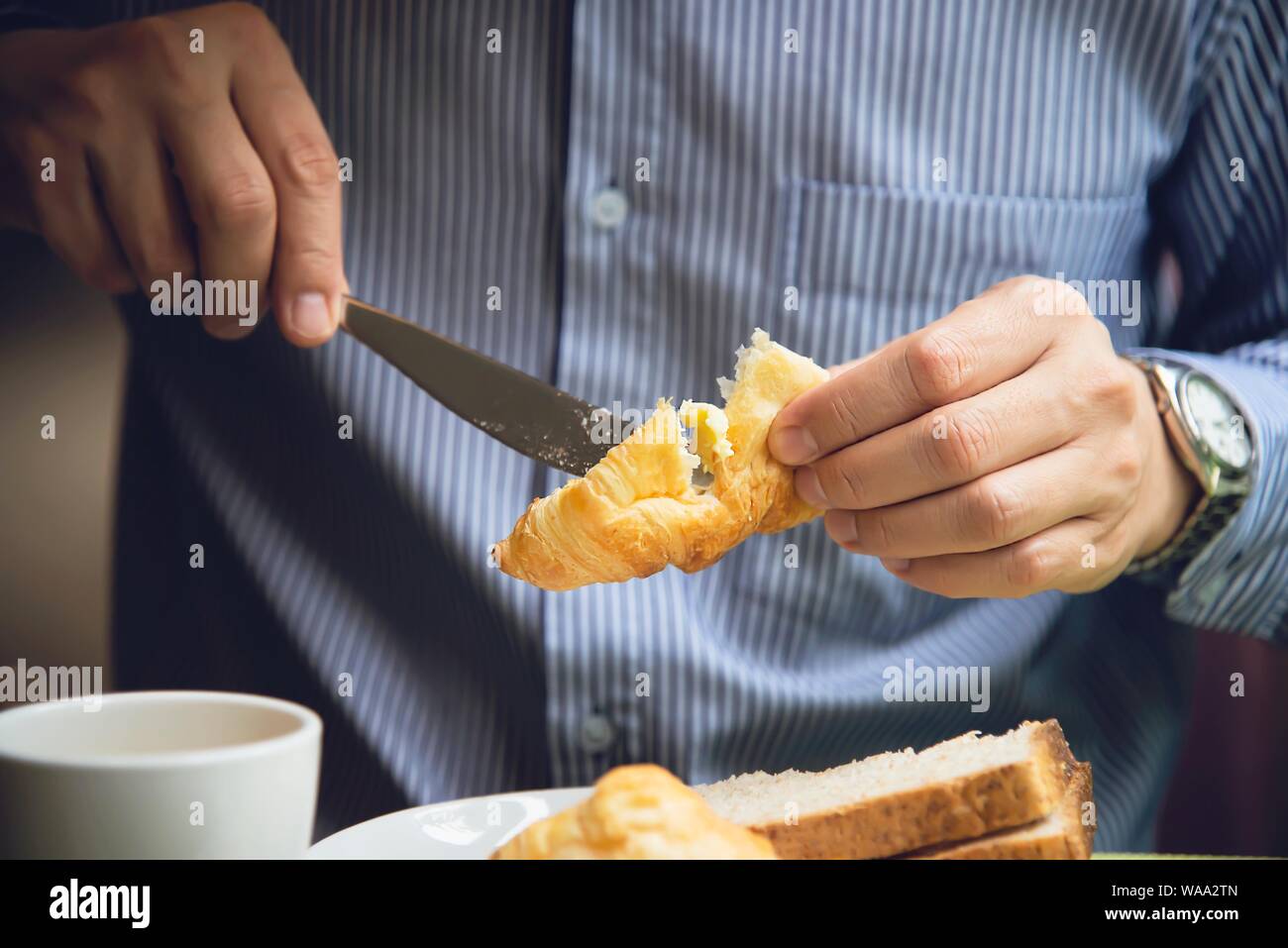 Business man eat the American breakfast set in a hotel - people take a breakfast in hotel concept Stock Photo