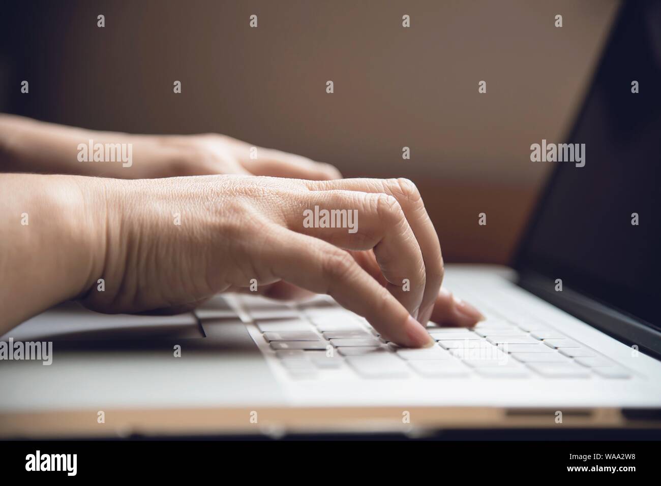 Lady finger touch or press laptop keyboard  - people working with technology concept Stock Photo