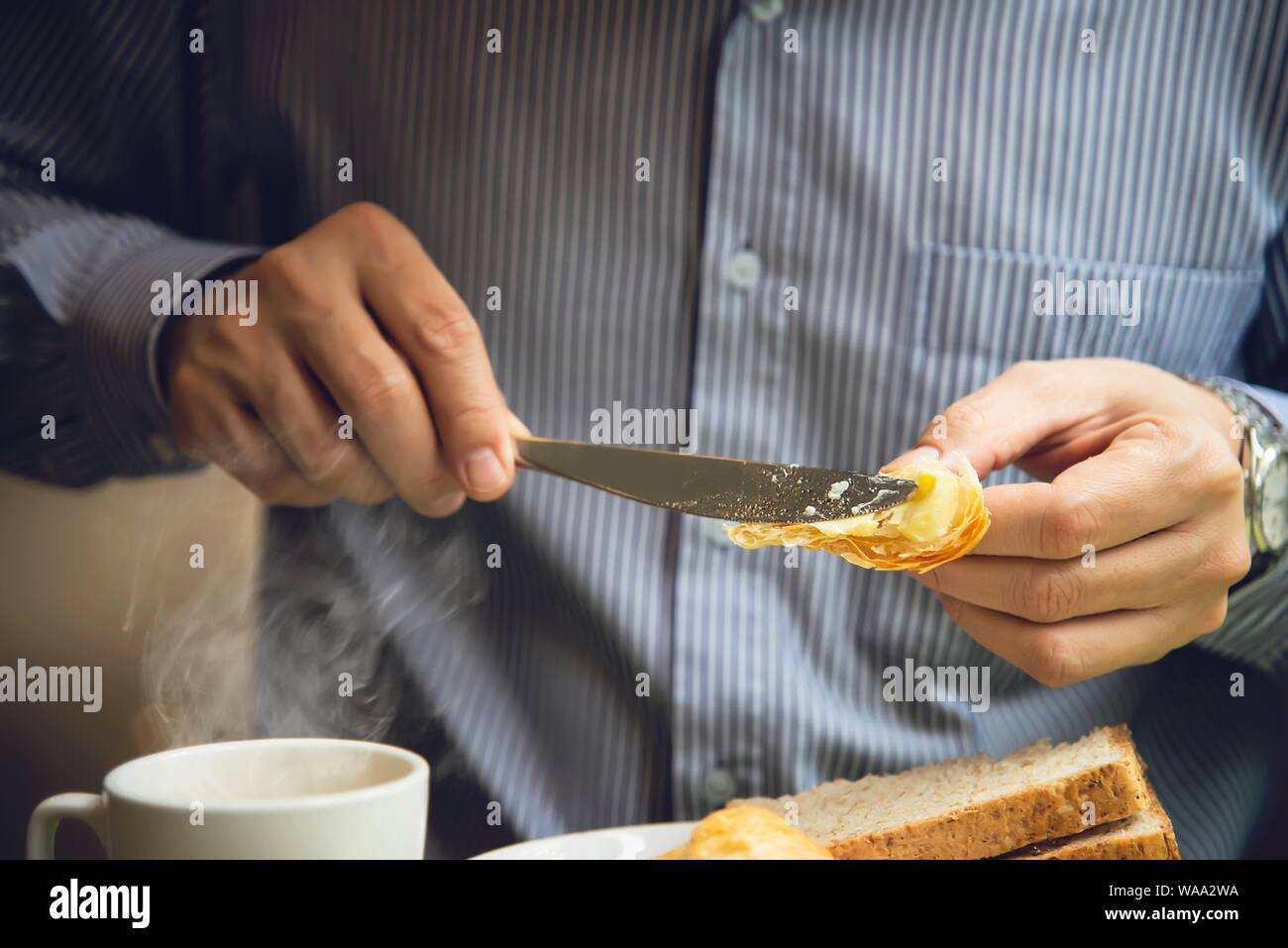 Business man eat the American breakfast set in a hotel - people take a breakfast in hotel concept Stock Photo