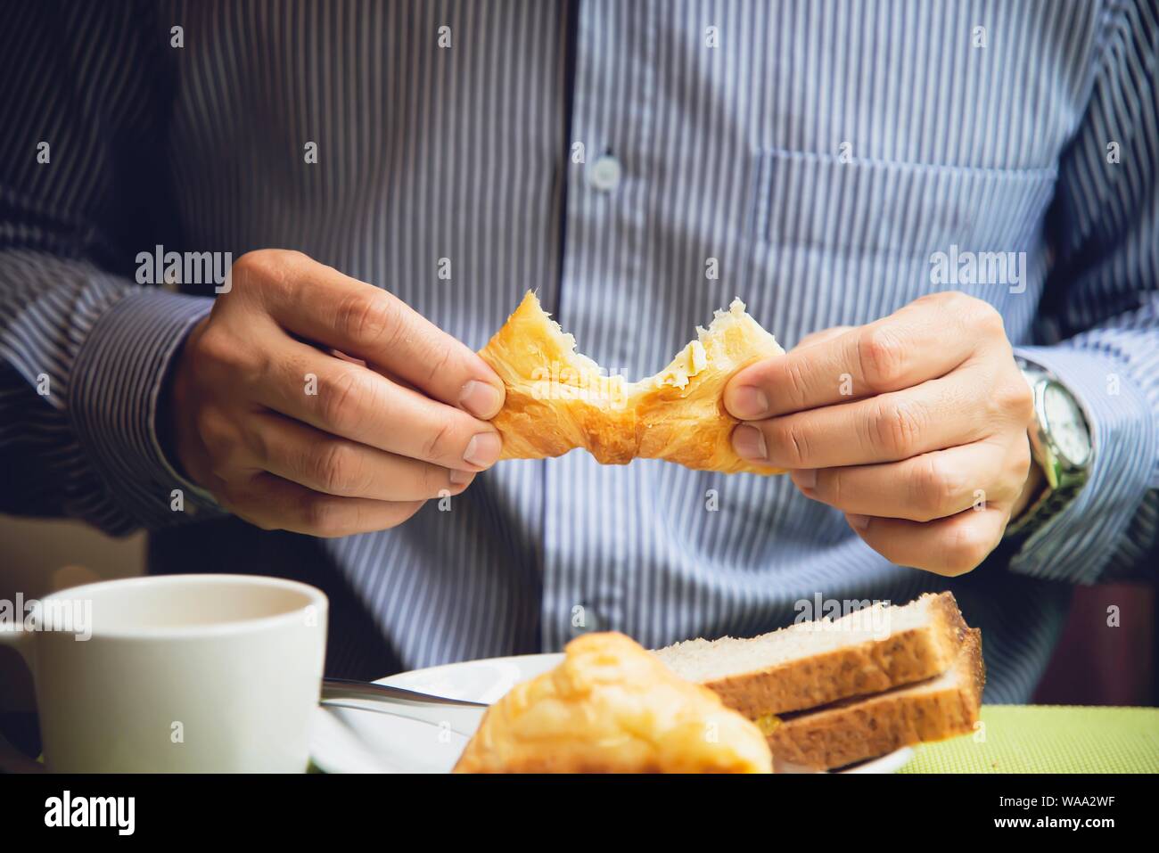 Business man eat the American breakfast set in a hotel - people take a breakfast in hotel concept Stock Photo