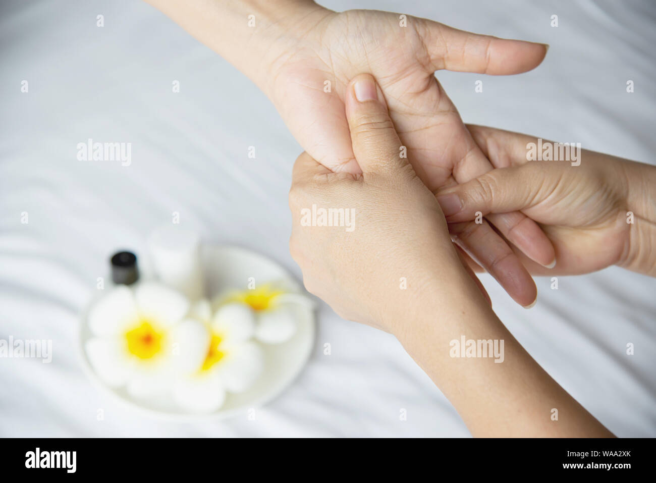 Hand spa massage over clean white bed background - people relax with hand massage service Stock Photo