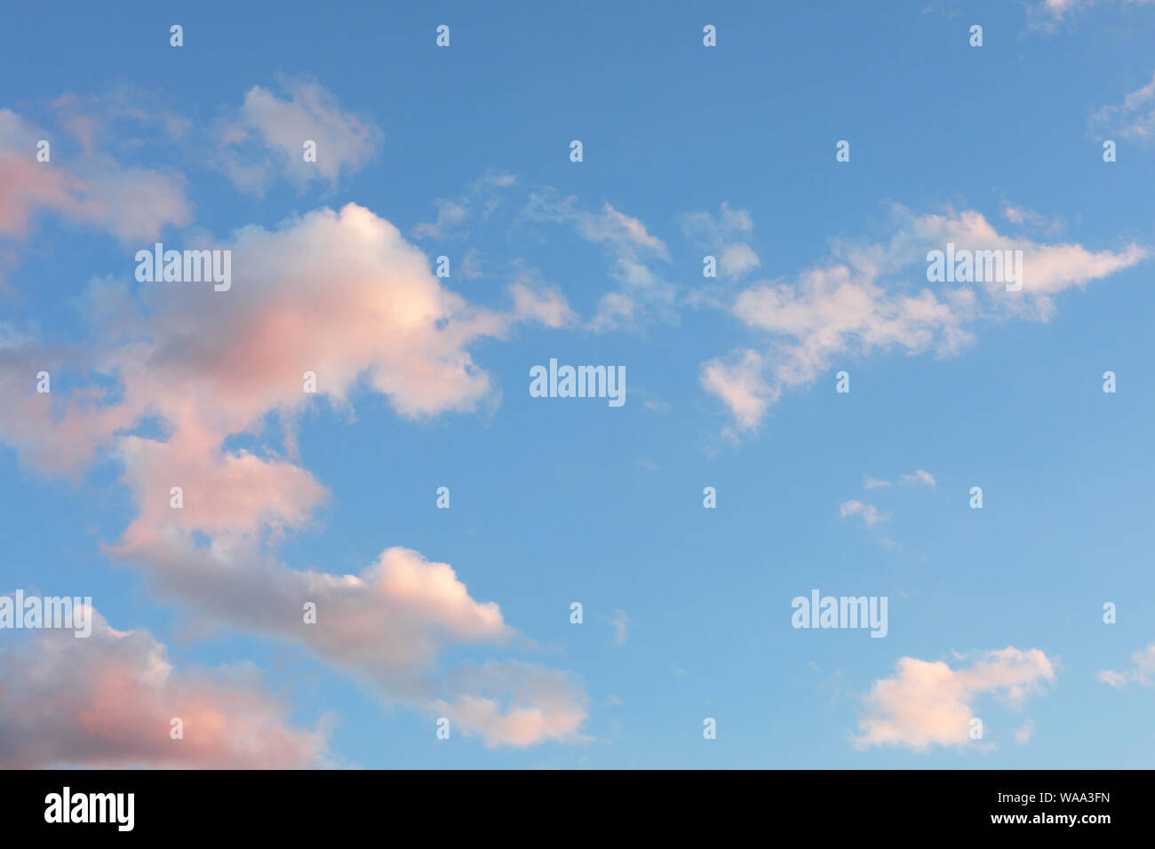 Blue sky with white, yellow and pink clouds. dawning Stock Photo