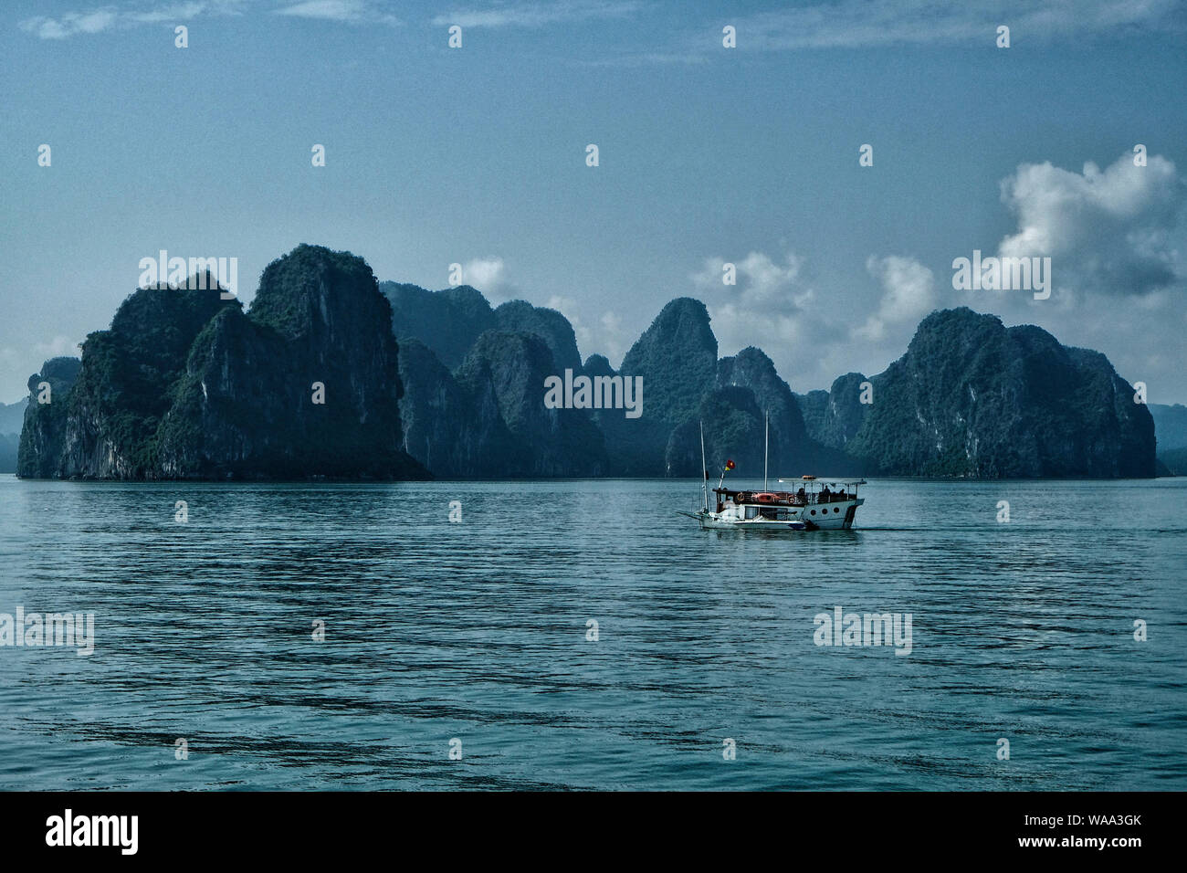 Halong, Vietnam - August 22: Tourists visiting Halong Bay by boat on August 22, 2018 in Halong, Vietnam. Stock Photo