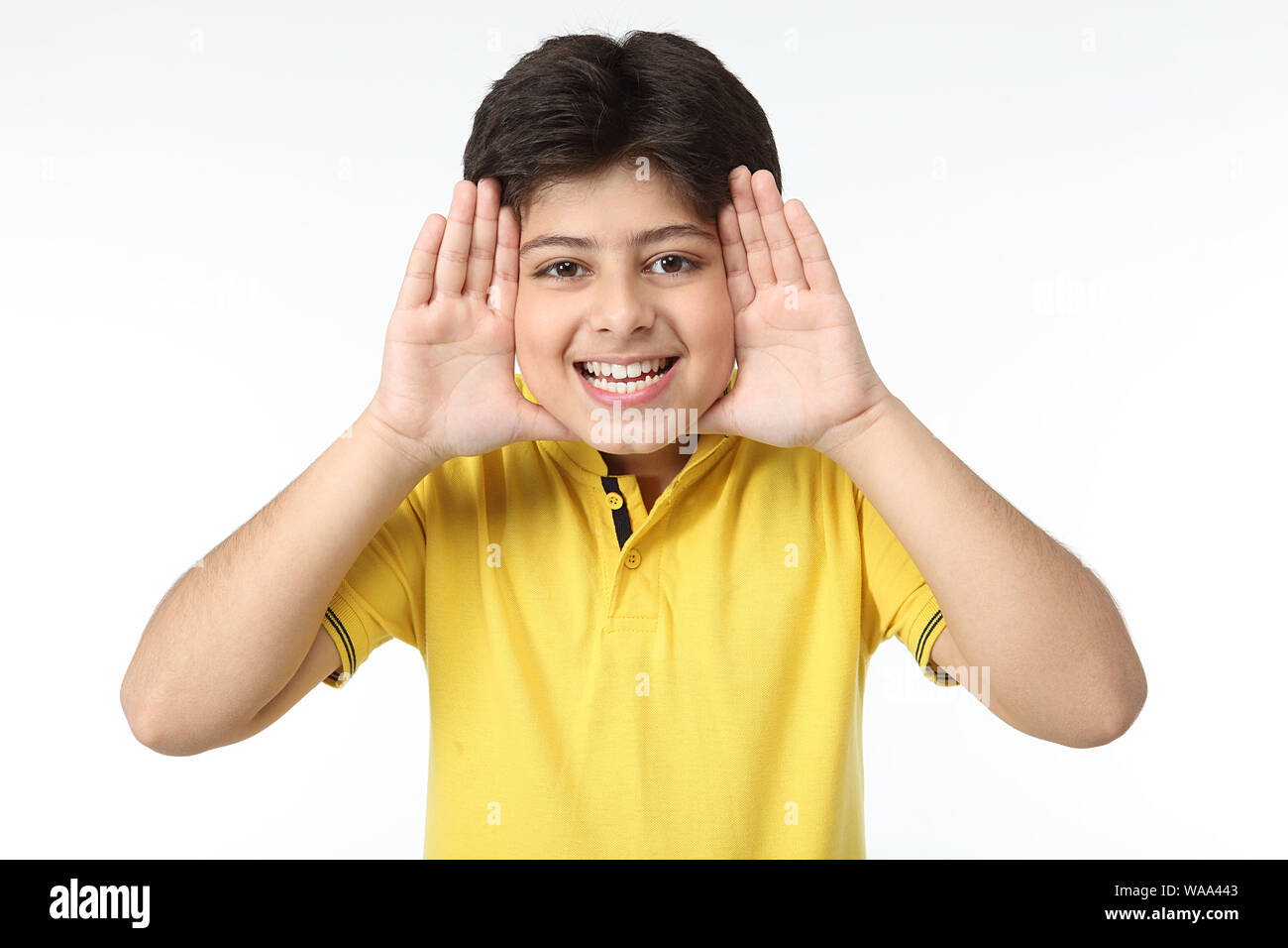 Boy framing face with fingers Stock Photo