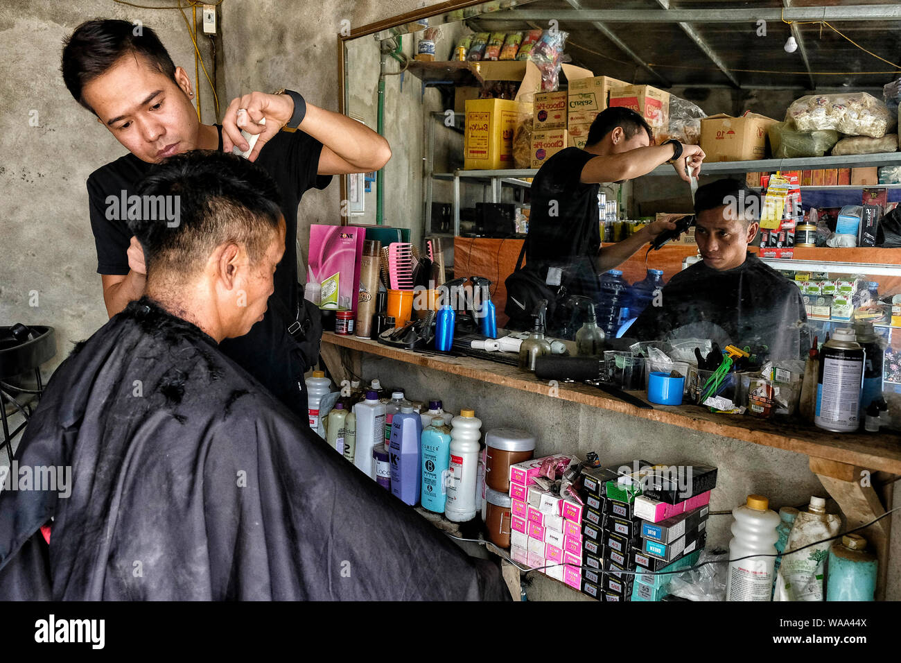 Sa Pa, Vietnam - August 23: Unidentified barber cutting hair for customer on August 23, 2018 in Sa Pa, Vietnam. Stock Photo