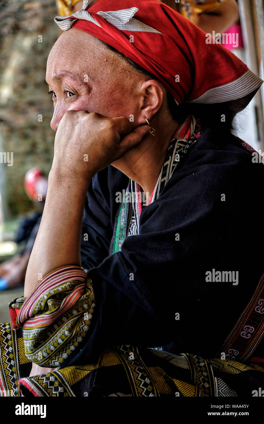 Ta Phin, Vietnam - August 24: Red Dao women sewing in the village on August 24, 2018 in Ta Phin. Red Dao people are Chinese minority in Vietnam. Stock Photo