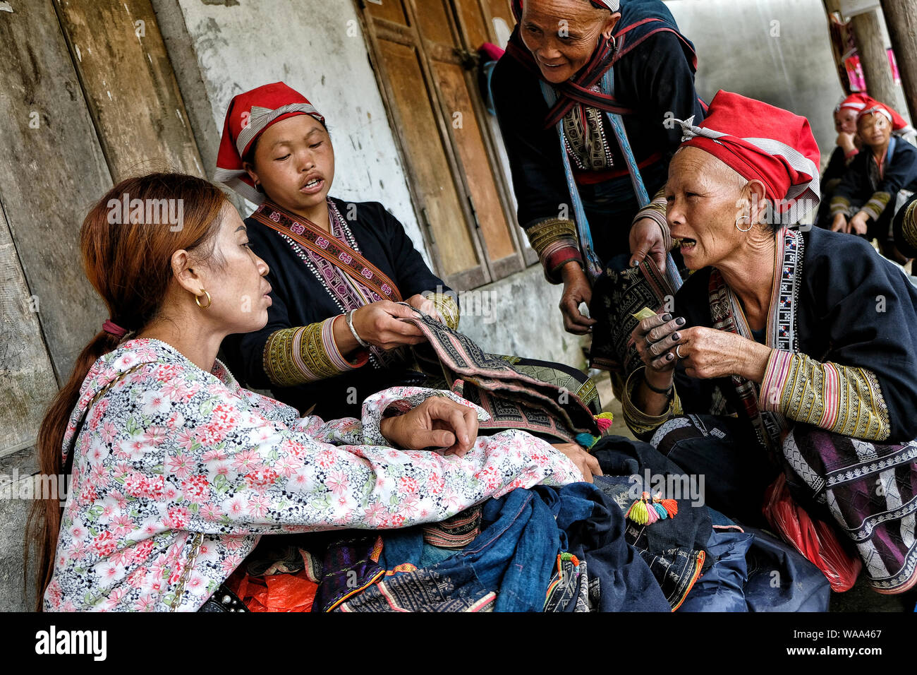 Ta Phin, Vietnam - August 24: Red Dao women sewing in the village on August 24, 2018 in Ta Phin. Red Dao people are Chinese minority in Vietnam. Stock Photo