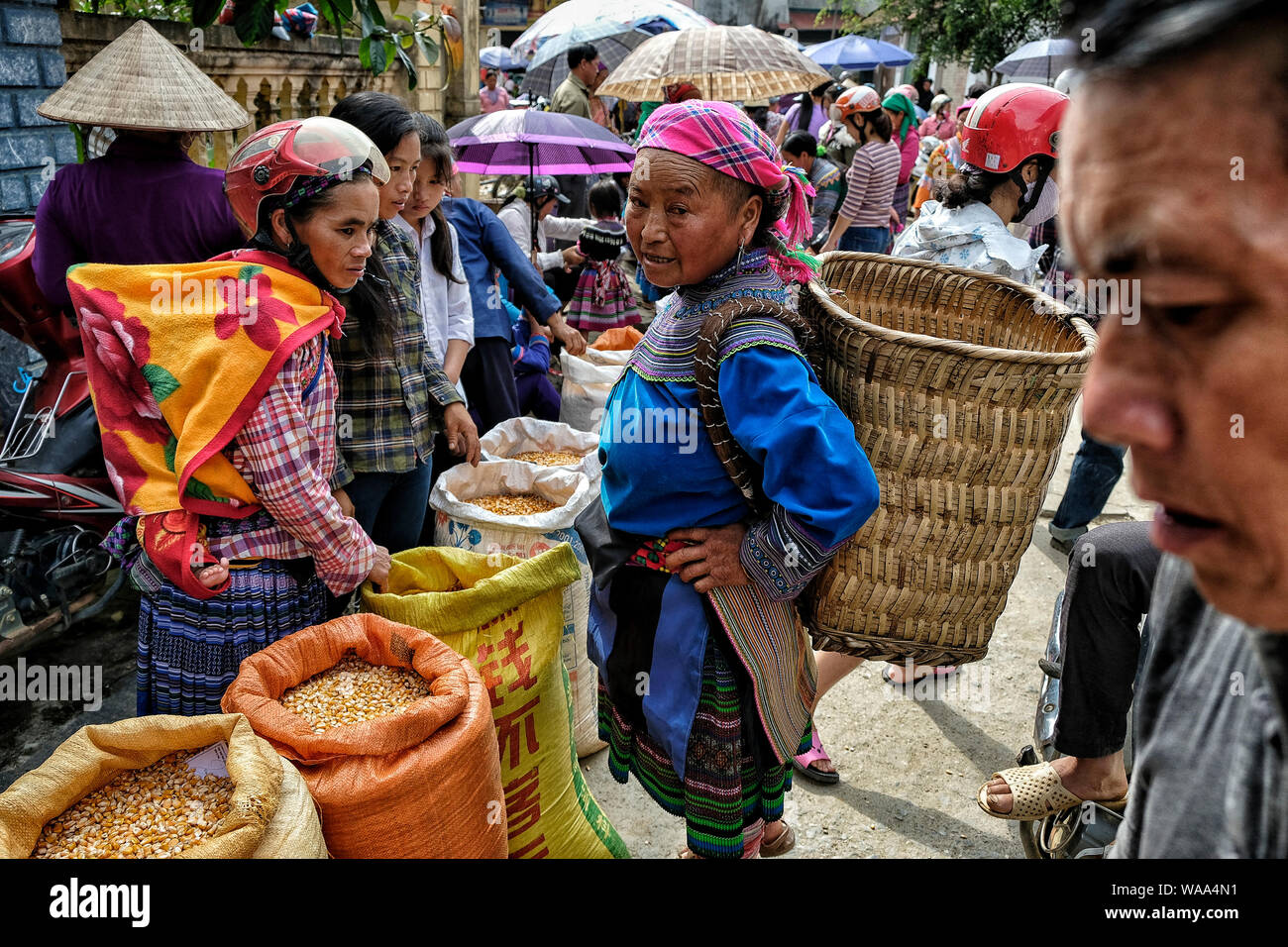 Bac Ha, Vietnam - August 26: Women of the Hmong Ethnic Minority People selling rice and corn at sunday market on August 26, 2018 in Bac Ha, Vietnam. Stock Photo