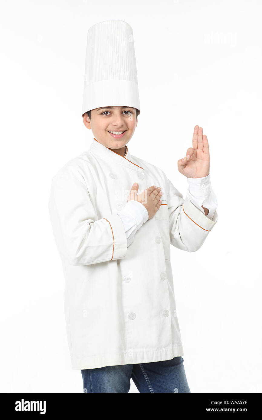 Boy pretending to be a chef and showing Ok sign Stock Photo