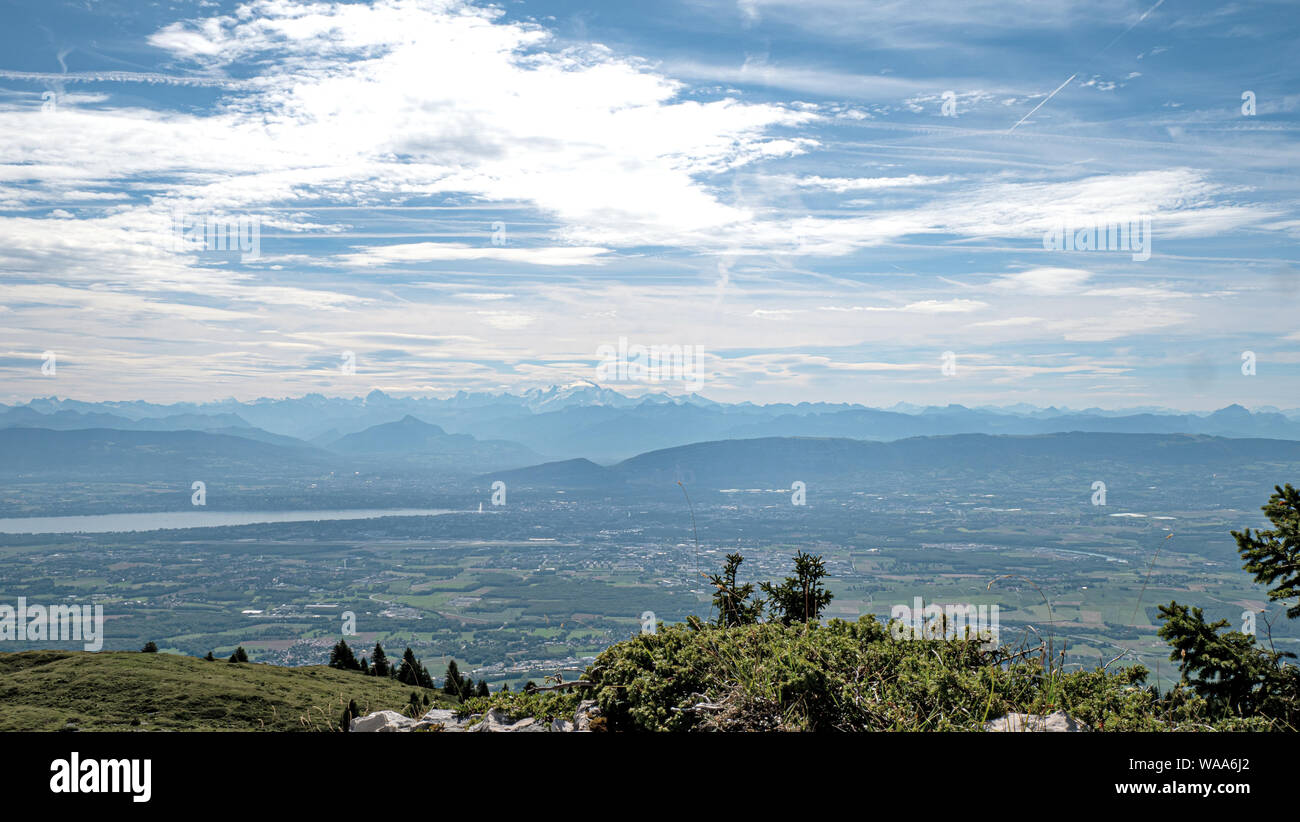 Views of alpine mountain peaks, valleys and lakes on a summer hazy day in Switzerland. Stock Photo