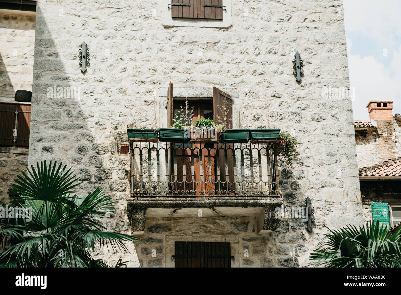 Close up view of a traditional old building with a balcony in Montenegro. Old house with a balcony Stock Photo