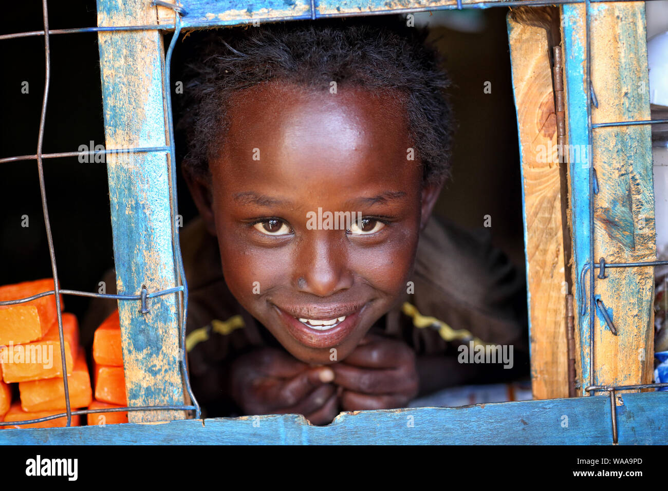 Happy girl in a small shop in a slum in Nairobi, Kenya Stock Photo