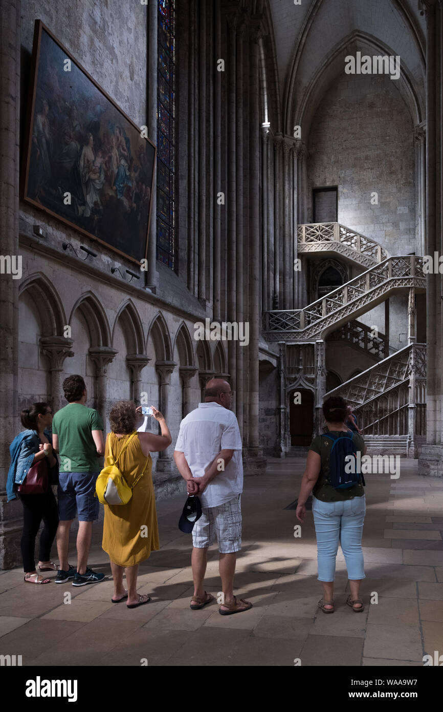 Tourists take photos of the 15th century Escalier de la Librarie (booksellers stairway) constructed by Guillaume Pontis inside Rouen Cathedral, France Stock Photo