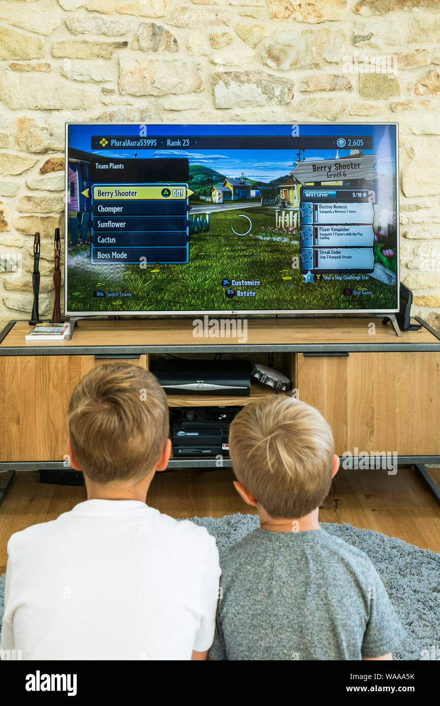 Young girl playing video games on computer after online school and  homework. Gamer using shooting action play for entertainment and fun with  keyboard and monitor. Child enjoying game Stock Photo - Alamy