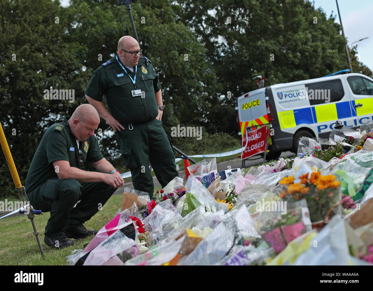 Ambulance paramedics pay their respects in front of tributes left at the scene near Ufton Lane, Sulhamstead, Berkshire, where Thames Valley Police officer Pc Andrew Harper, 28, died following a 'serious incident' at about 11.30pm on Thursday near the A4 Bath Road, between Reading and Newbury, at the village of Sulhamstead in Berkshire. Stock Photo