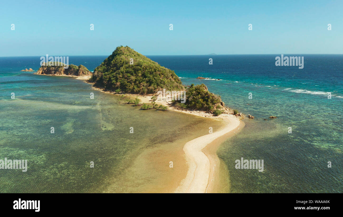 aerial view tropical island in blue lagoon, coral reef and sandy beach ...