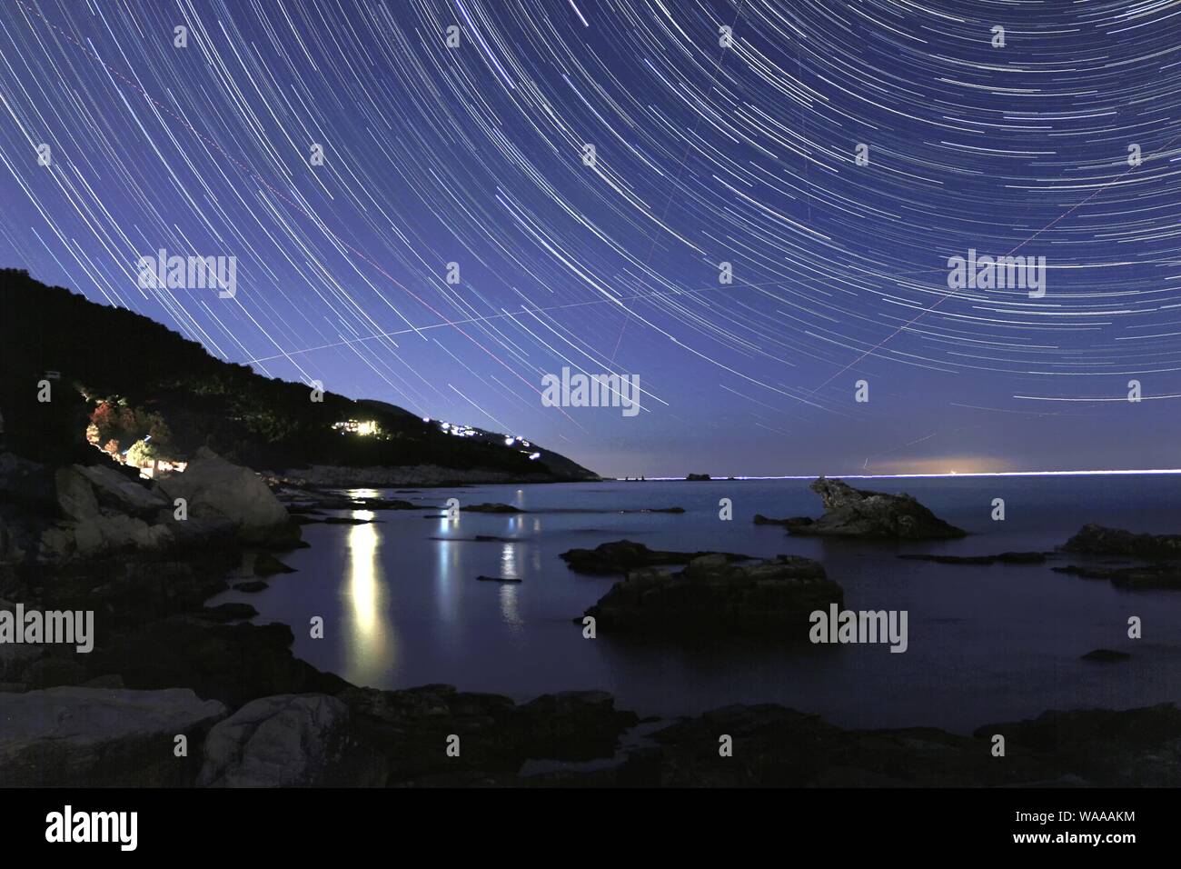Startrails with the see in Greece Stock Photo