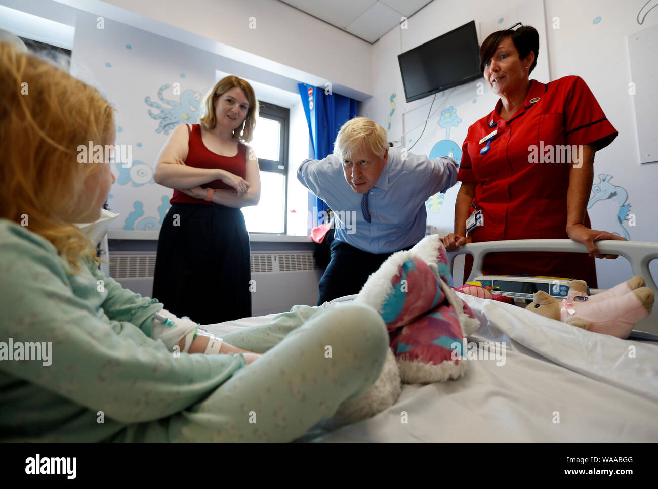 Prime Minister Boris Johnson talks to patient Scarlett Gibbons, 5, during a visit to the Royal Cornwall Hospital in Truro, Cornwall. Stock Photo