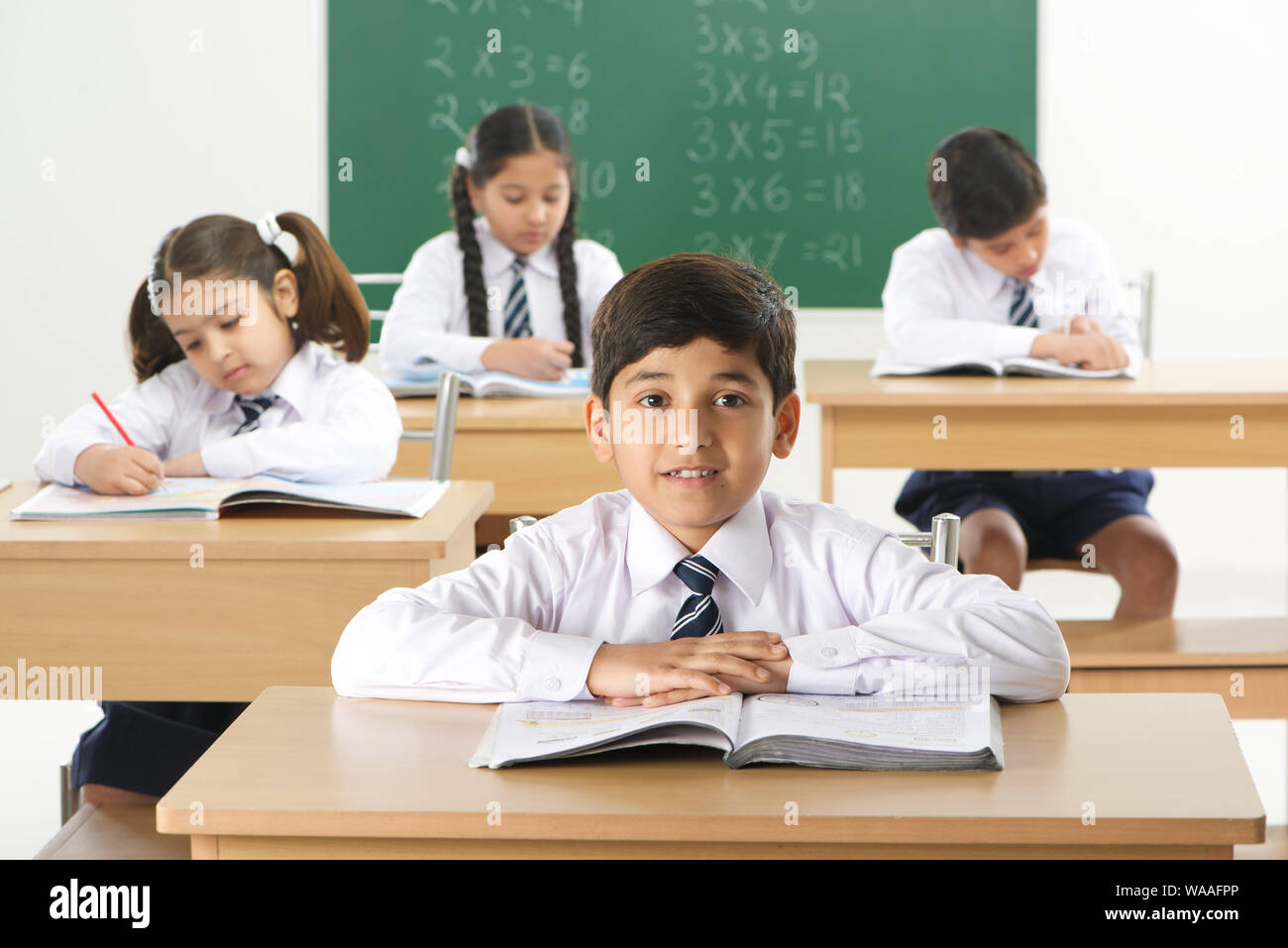 School children studying in a classroom Stock Photo - Alamy