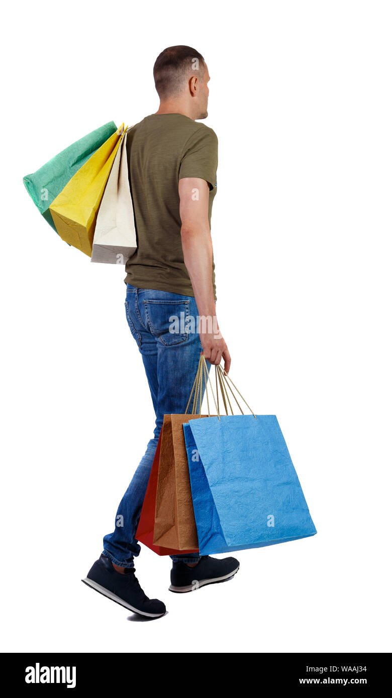 Person Walking On Sidewalk With Tommy Hilfiger Shopping Bag Stock