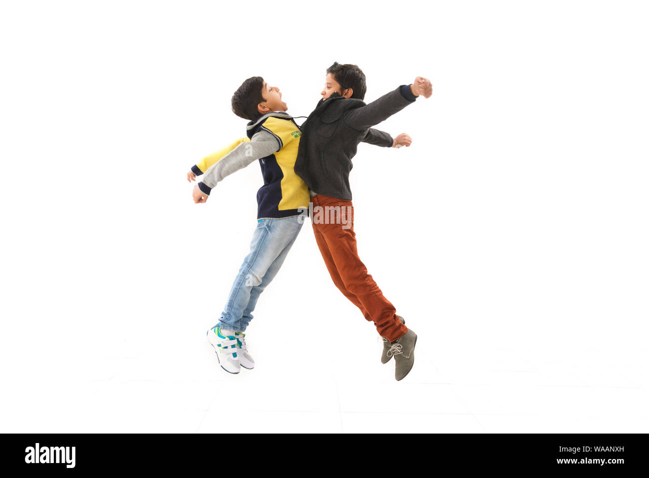 Two boys hitting chests together Stock Photo