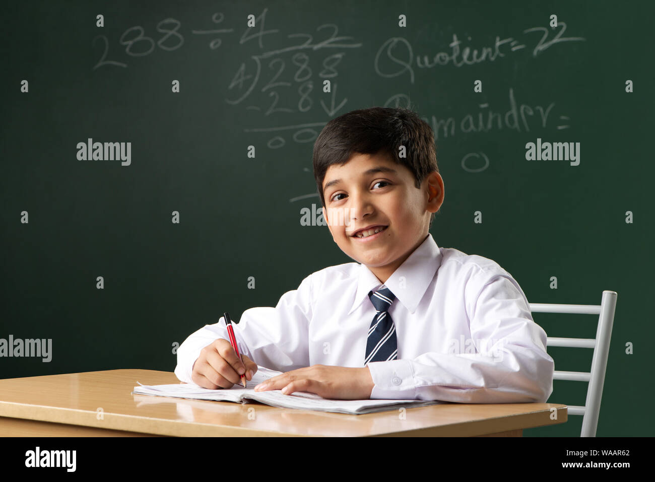 Schoolboy studying in a classroom Stock Photo - Alamy