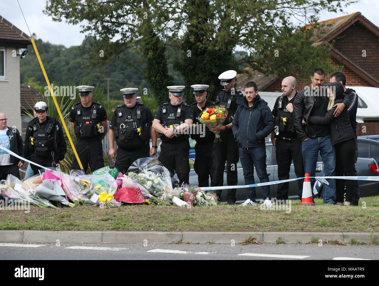 Members of the Thames Valley and Hampshire Roads Policing Team pay their respects in front of tributes at the scene near Ufton Lane, Sulhamstead, Berkshire, where Thames Valley Police officer Pc Andrew Harper, 28, died following a 'serious incident' at about 11.30pm on Thursday near the A4 Bath Road, between Reading and Newbury, at the village of Sulhamstead in Berkshire. Stock Photo