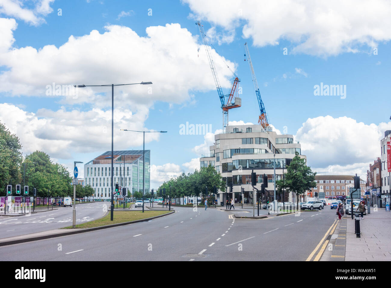 A view down the A4 towards Slough town centre. Large construction cranes point to the sky as part of redevelopment work going on in Slough. Stock Photo