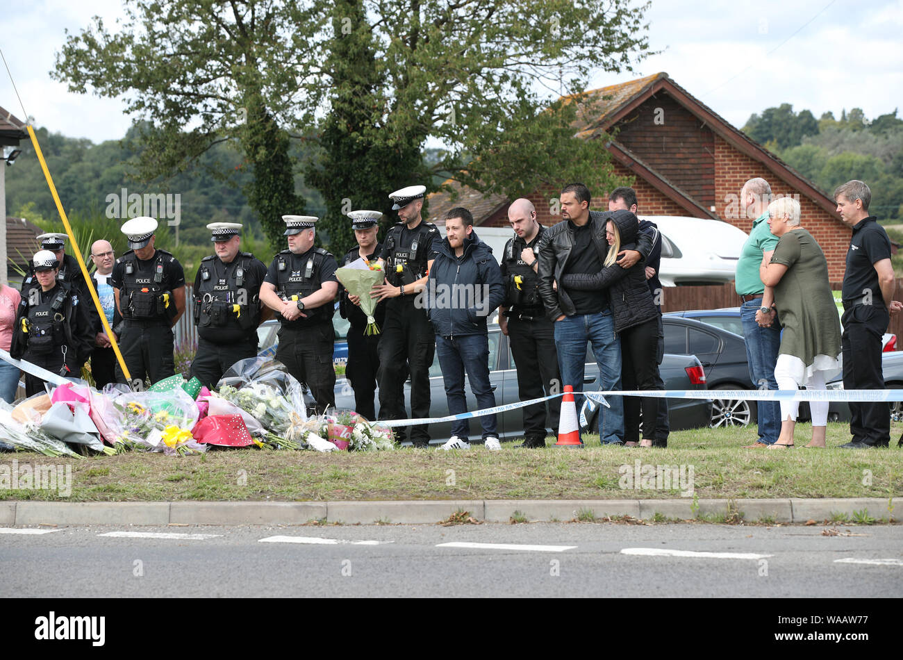 Members of the Thames Valley and Hampshire Roads Policing Team pay their respects in front of tributes at the scene near Ufton Lane, Sulhamstead, Berkshire, where Thames Valley Police officer Pc Andrew Harper, 28, died following a 'serious incident' at about 11.30pm on Thursday near the A4 Bath Road, between Reading and Newbury, at the village of Sulhamstead in Berkshire. Stock Photo