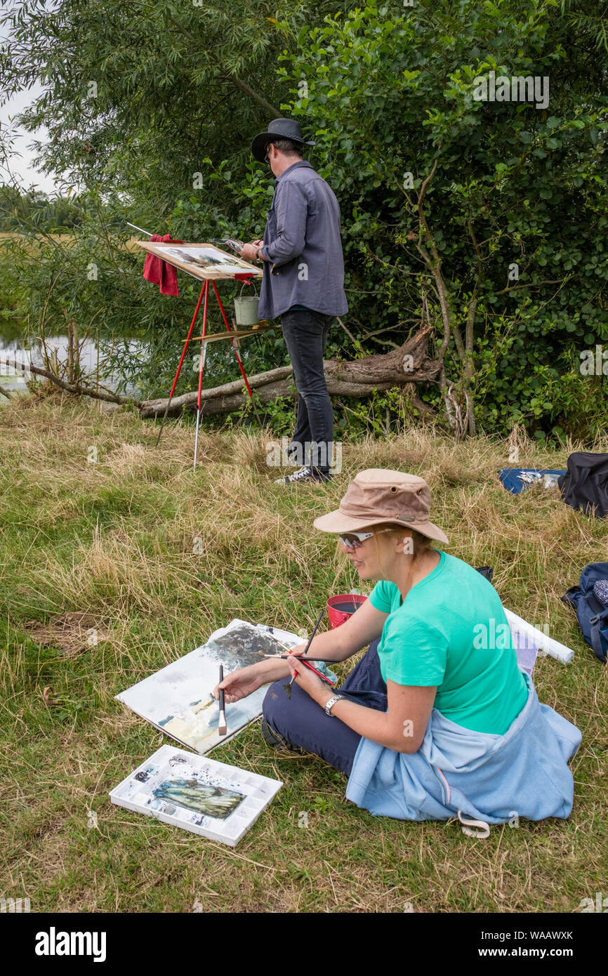 Artists painting outdoors in on the River Stour, Dedham Vale, Suffolk ANOB, England, UK Stock Photo