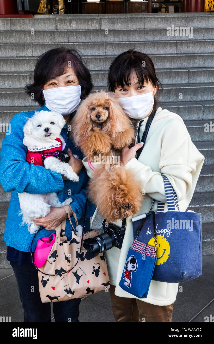 Japan, Honshu, Tokyo, Asakusa, Women with Allergy Masks Holding Pet