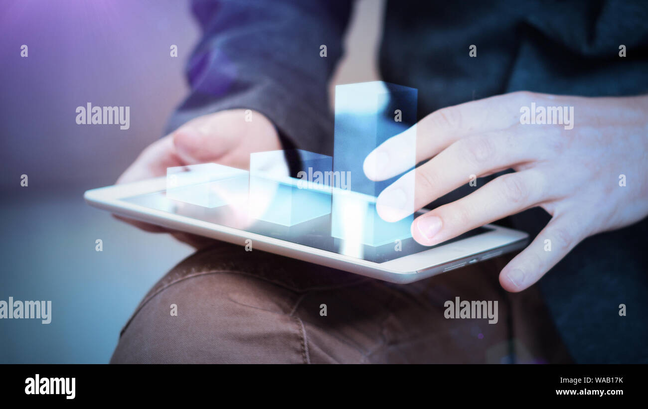 businessman interacts with hologram chart on a tablet Stock Photo