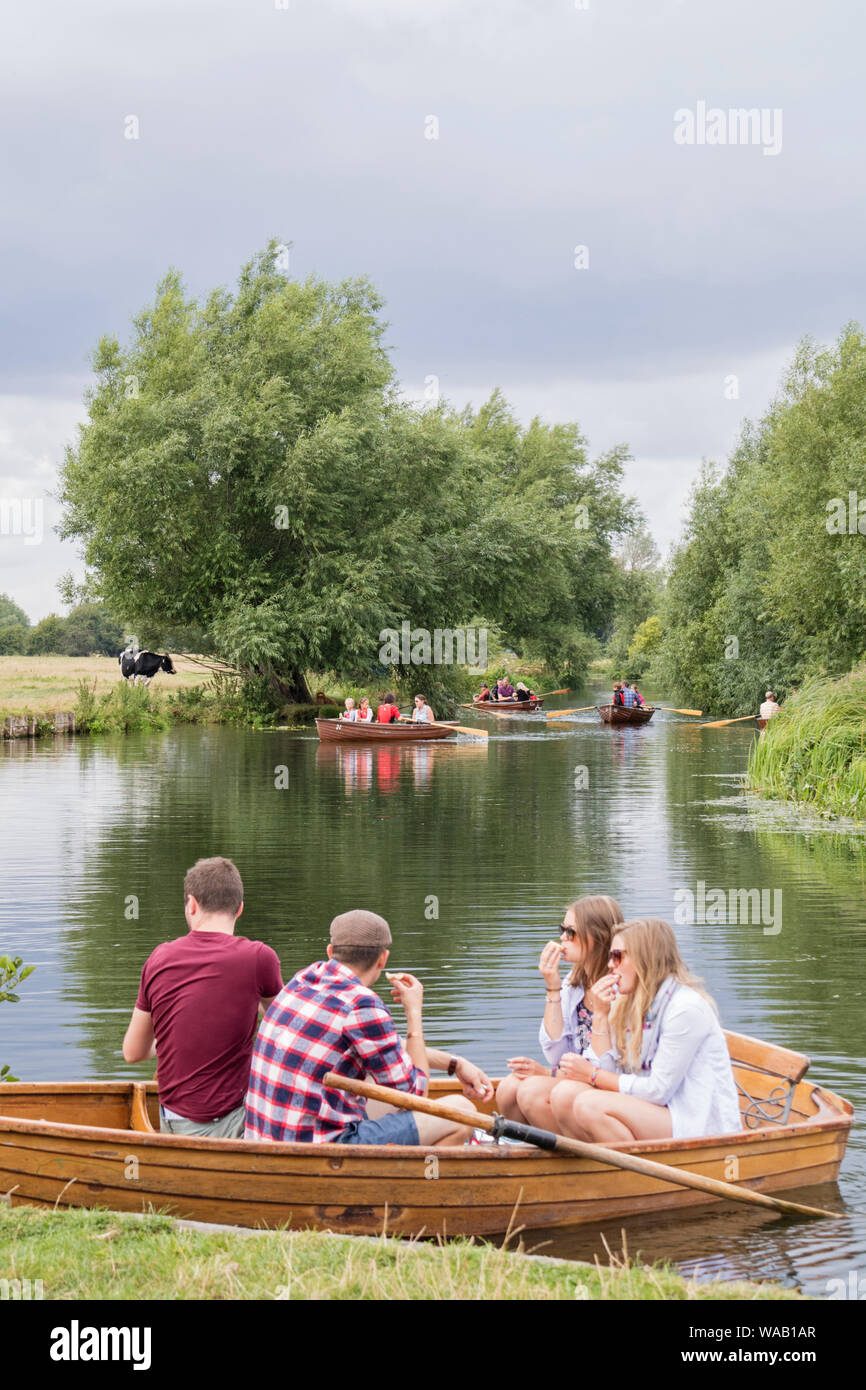 Visitors to Flatford Mill hire rowing boats to explore the River Stour