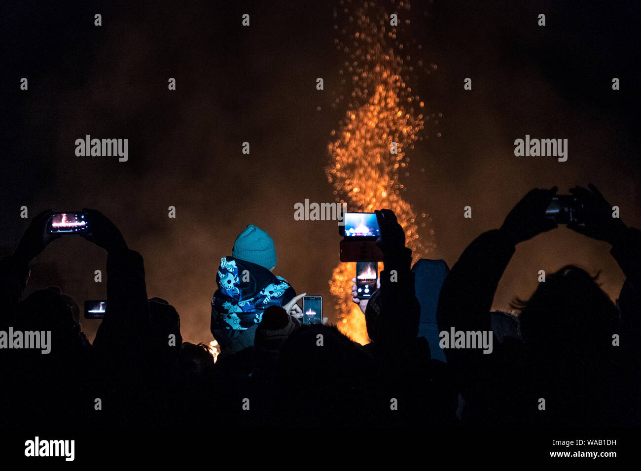 Crowds of people try to catch a glimpse of the burning of the galley at the 2019 Up Helly Aa festival in Lerwick, Shetland - (landscape view) Stock Photo