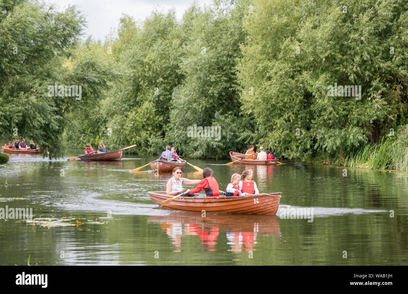 Visitors to Flatford Mill hire rowing boats to explore the River Stour