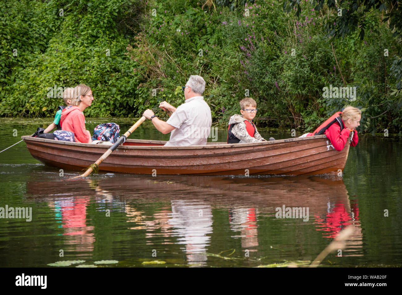 Visitors to Flatford Mill hire rowing boats to explore the River Stour
