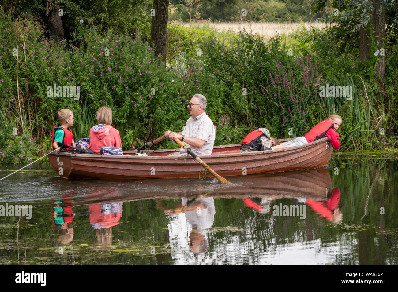 Visitors to Flatford Mill hire rowing boats to explore the River Stour