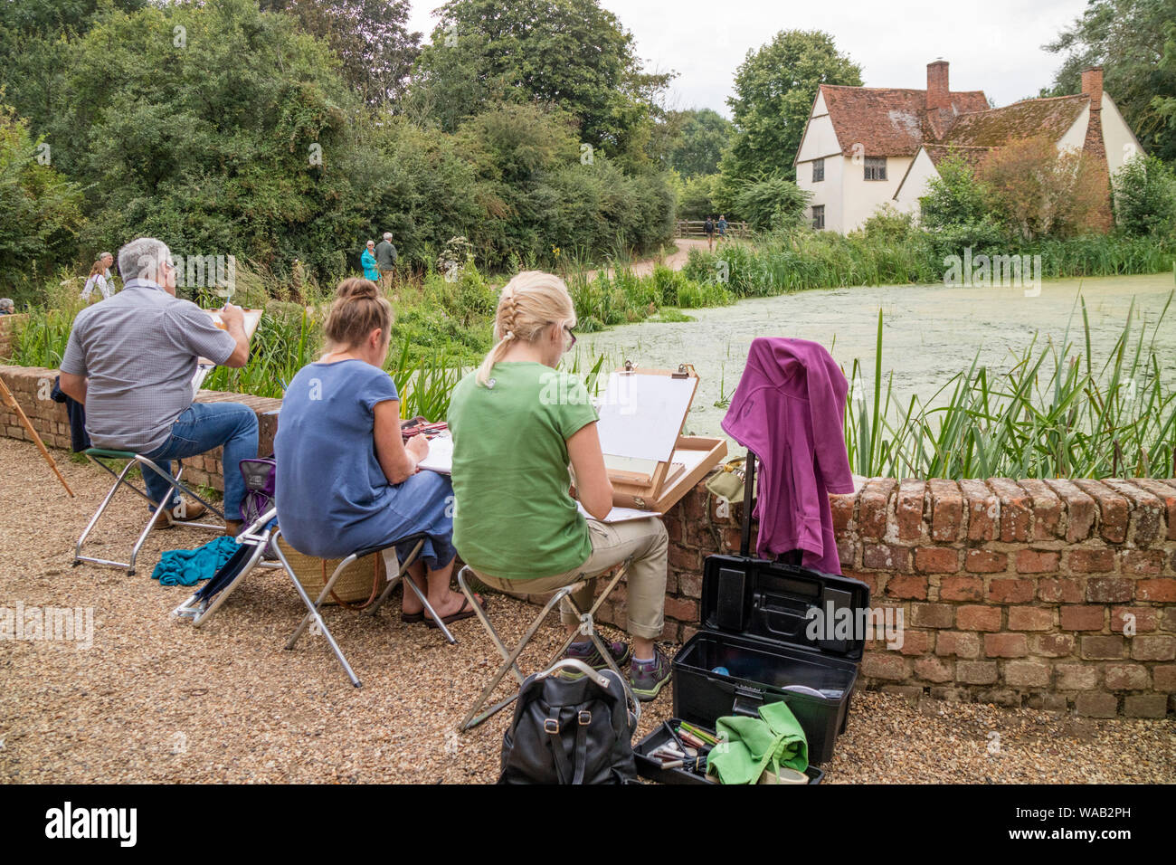 Artists painting Willy Lott's house at the National Trust's Flatford Mill made famous by the artist John Constable 1776 -1837,  Suffolk, England, UK Stock Photo