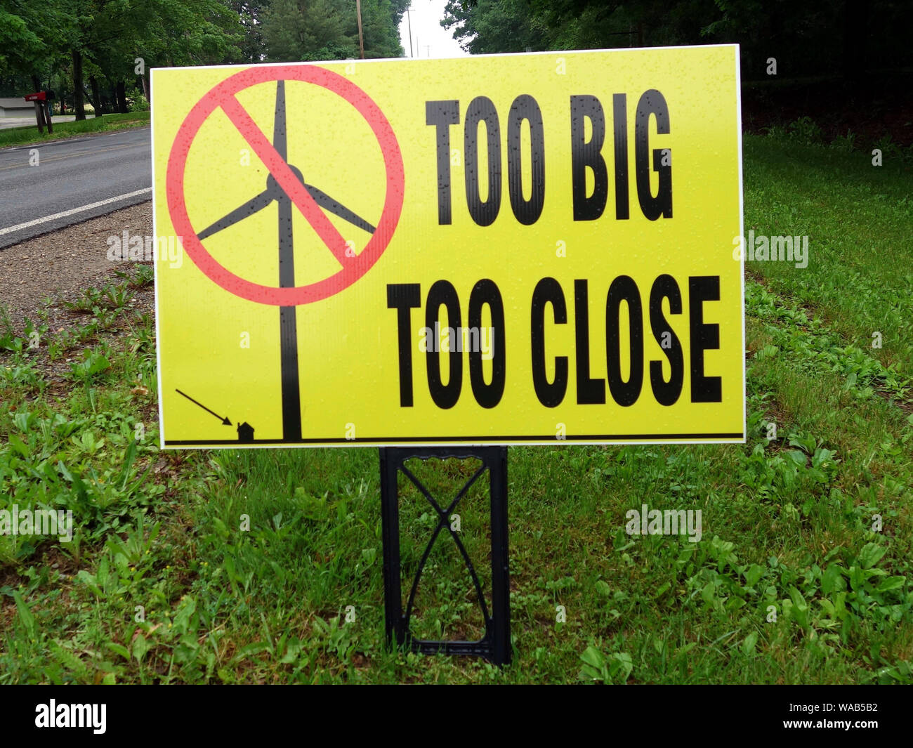 A sign suggesting that electric power windmills are too big and too close to homes. Stock Photo