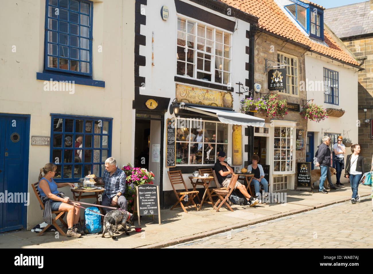 People sitting outside Marie Antoinettes cafe in Church St, Whitby, Yorkshire, England, UK Stock Photo