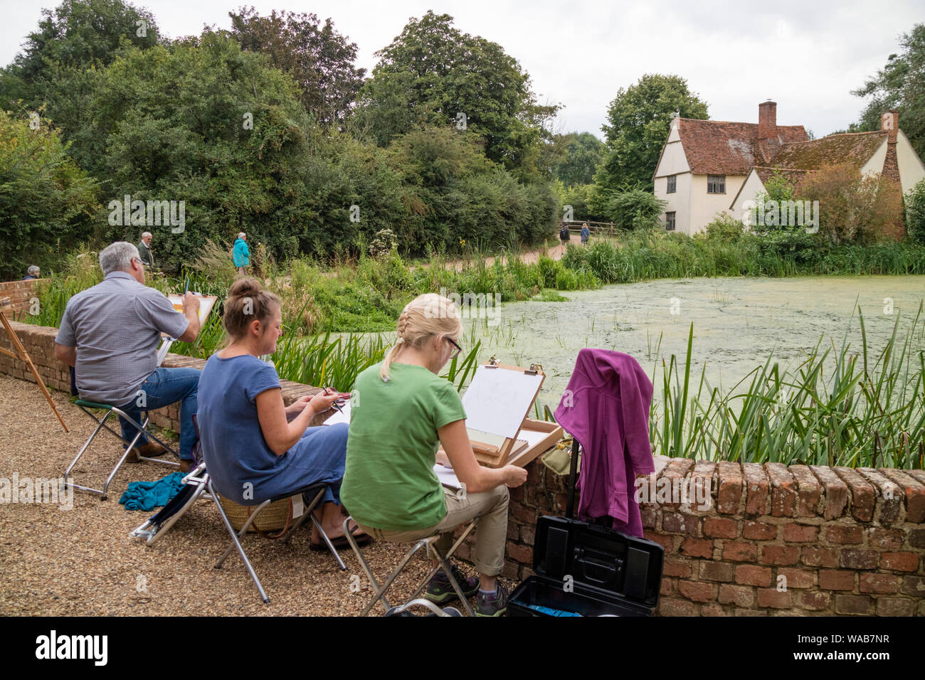 Artists painting Willy Lott's house at the National Trust's Flatford Mill made famous by the artist John Constable 1776 -1837,  Suffolk, England, UK Stock Photo