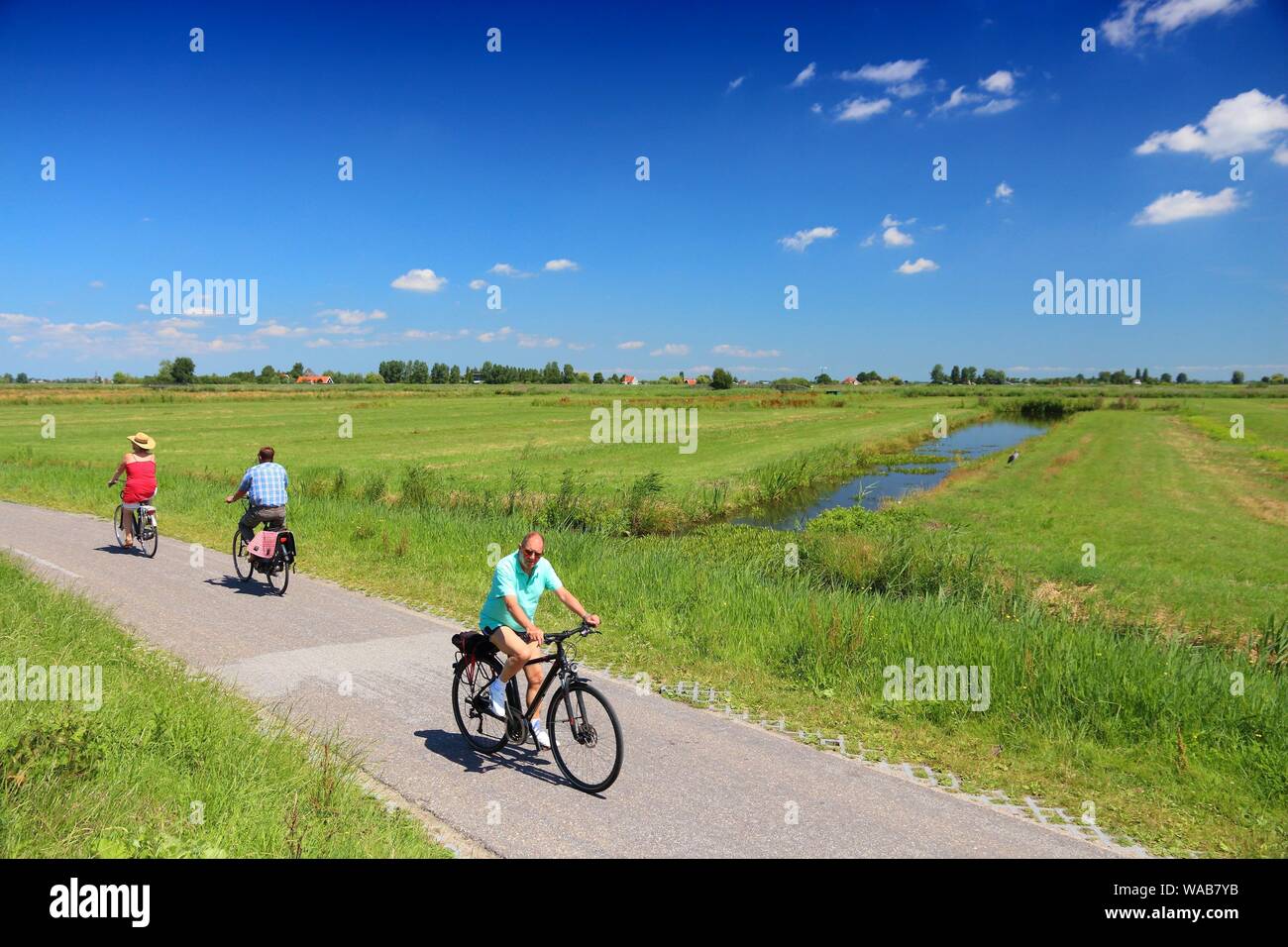 ZAANDAM, NETHERLANDS - JULY 9, 2017: Cyclists visit polder countryside of  Kalverpolder in Zaandam. Netherlands has 35,000 km of cycleways physically  s Stock Photo - Alamy