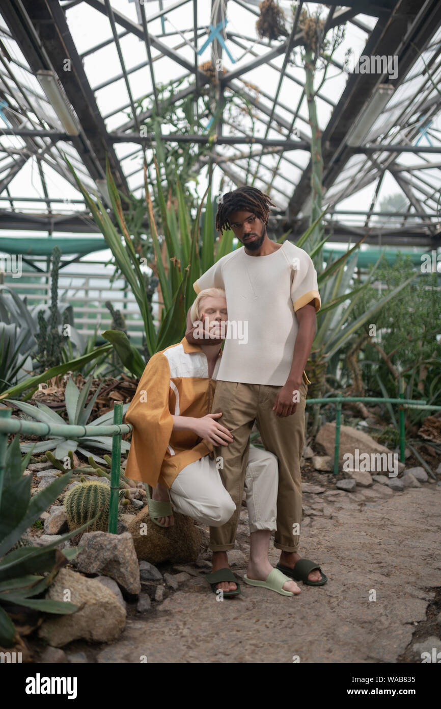 Models Showing Poses. Two Male Models Wearing Summer Clothes Showing Poses  In The Greenhouse Stock Photo, Picture and Royalty Free Image. Image  128998273.