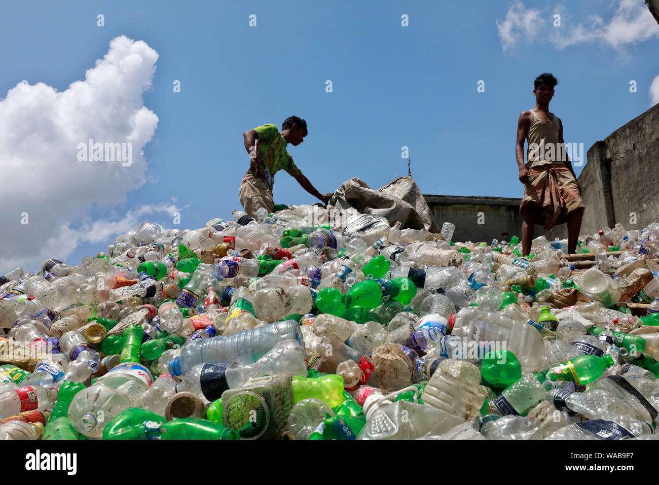 Dhaka, Bangladesh August 19, 2019 A Bangladeshi worker collects plastic bottles for recycle