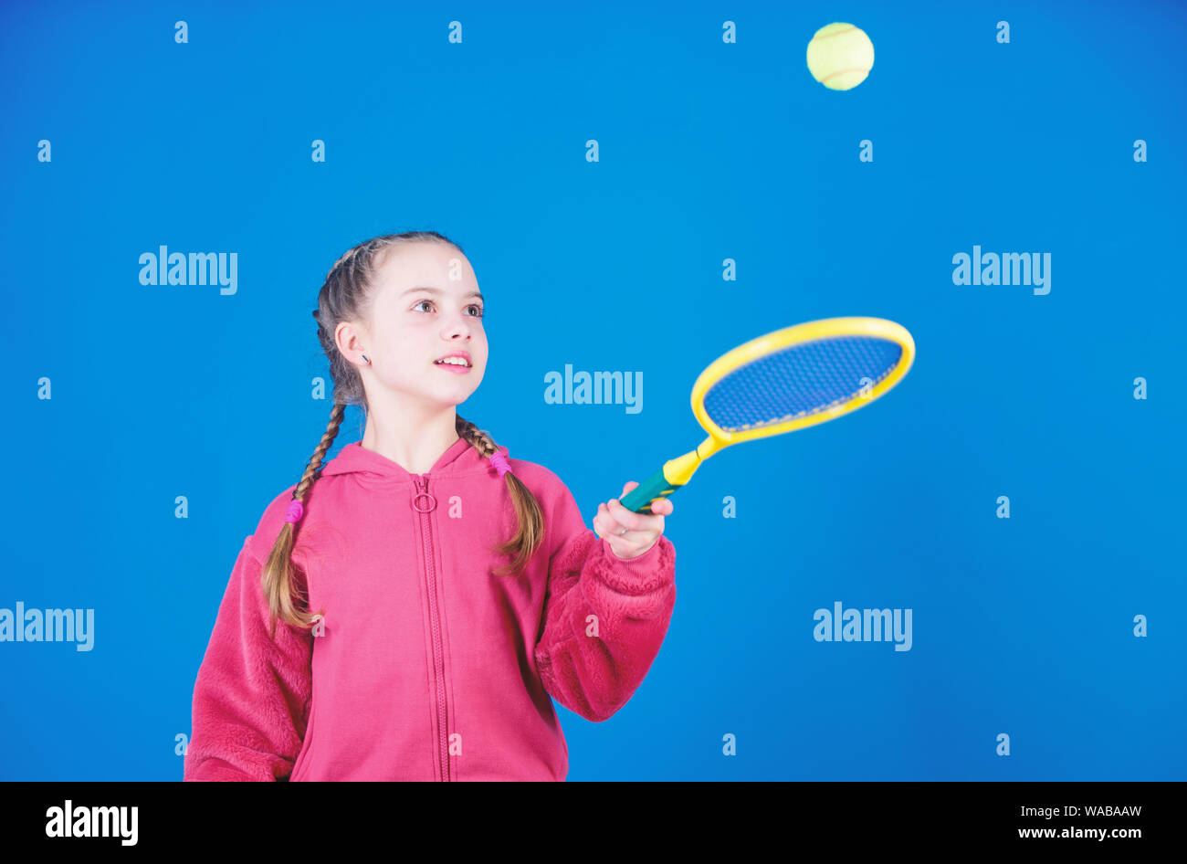 Girl adorable child play tennis. Practicing tennis skills and having