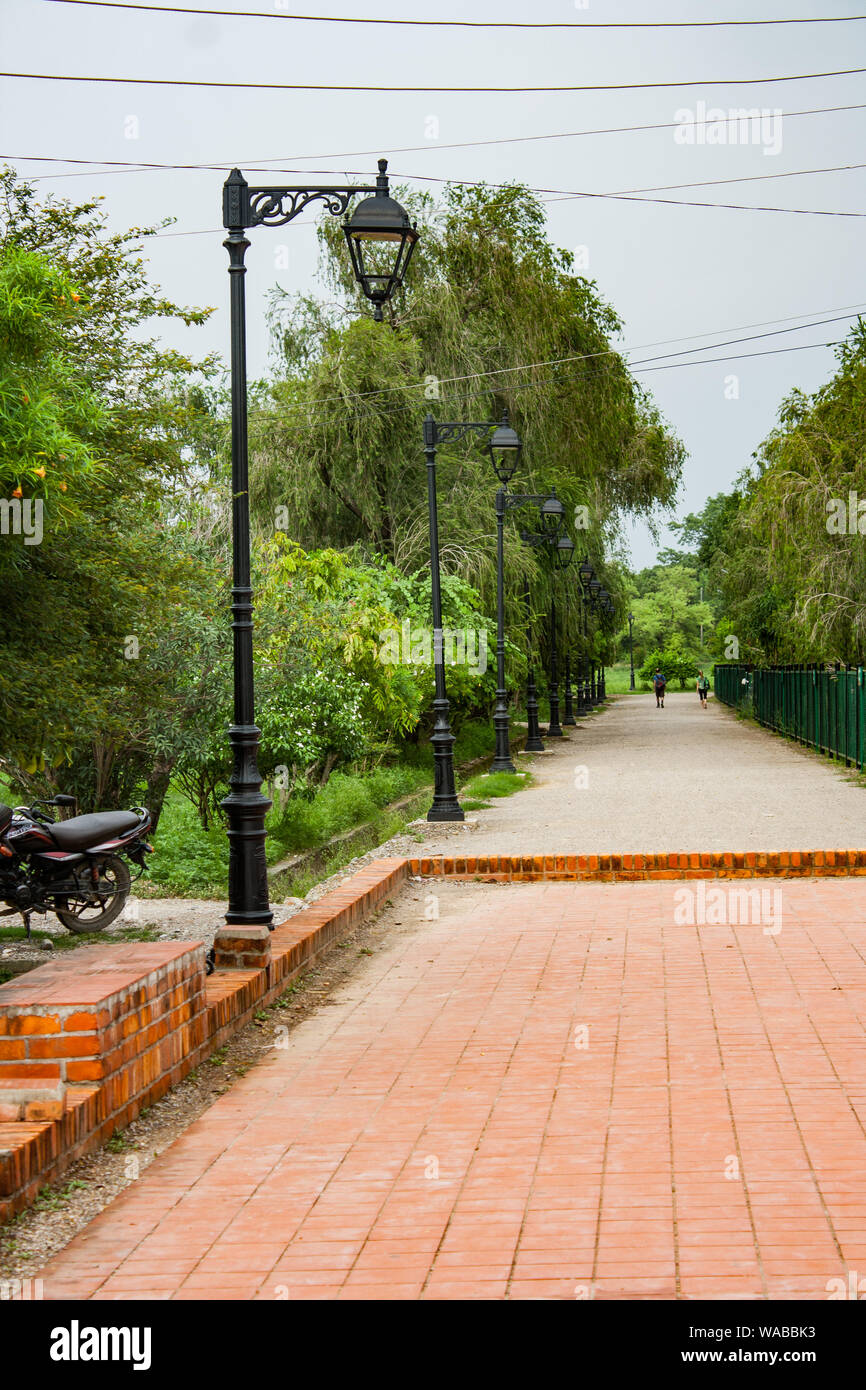 Brick paved road with street lamp inside Lumbini Garden, The Birthplace ...