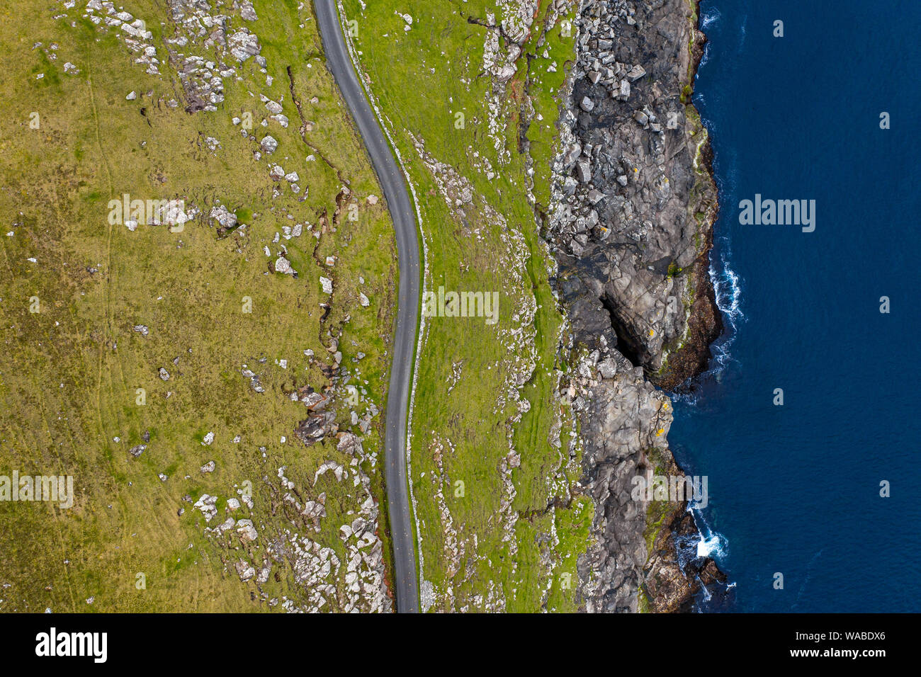 Road near the cliffs of Sandur in Sandoy island aerial view, Faroe Islands Stock Photo