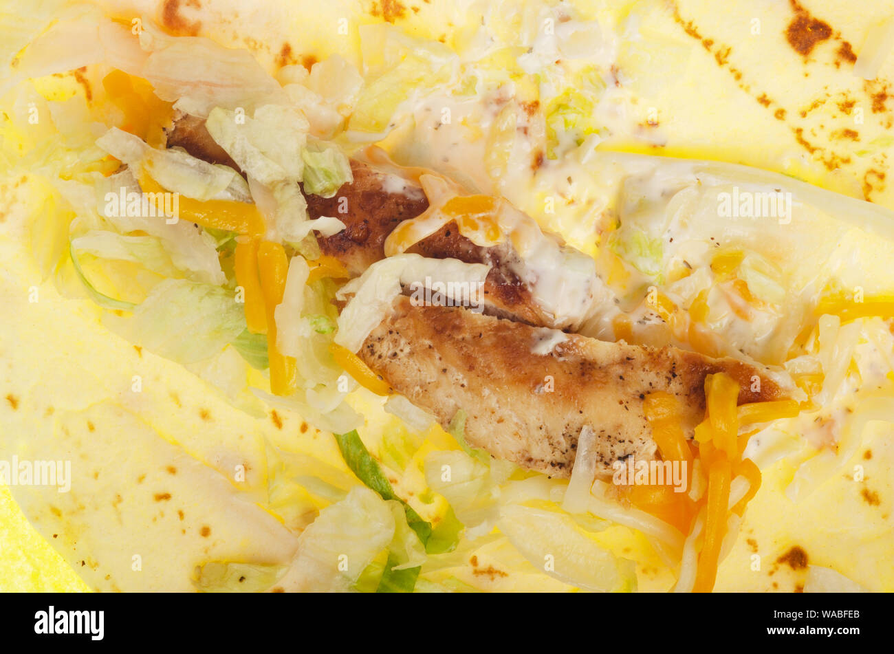 McDonald’s ranch grilled chicken snack wrap unwrapped inside showing filling ingredients Stock Photo