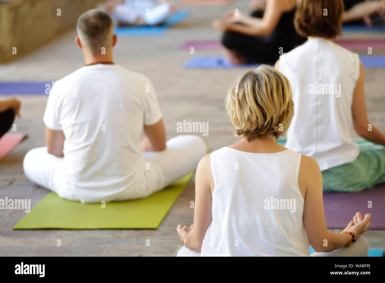 People Practicing Yoga Lesson Stock Photo